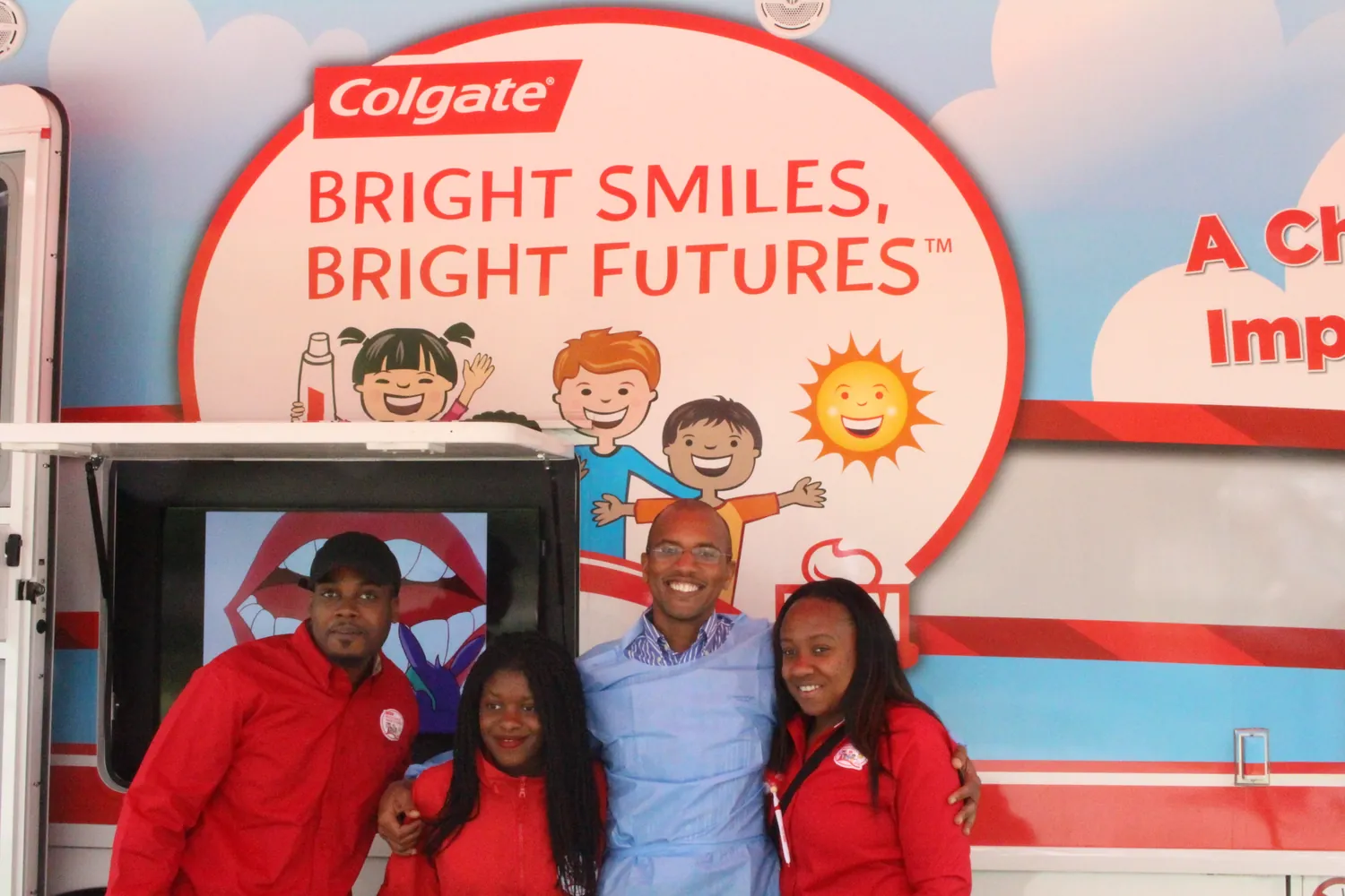 Dr. Shirley with the Colgate Bright Smiles, Bright Futures team in front of the program van