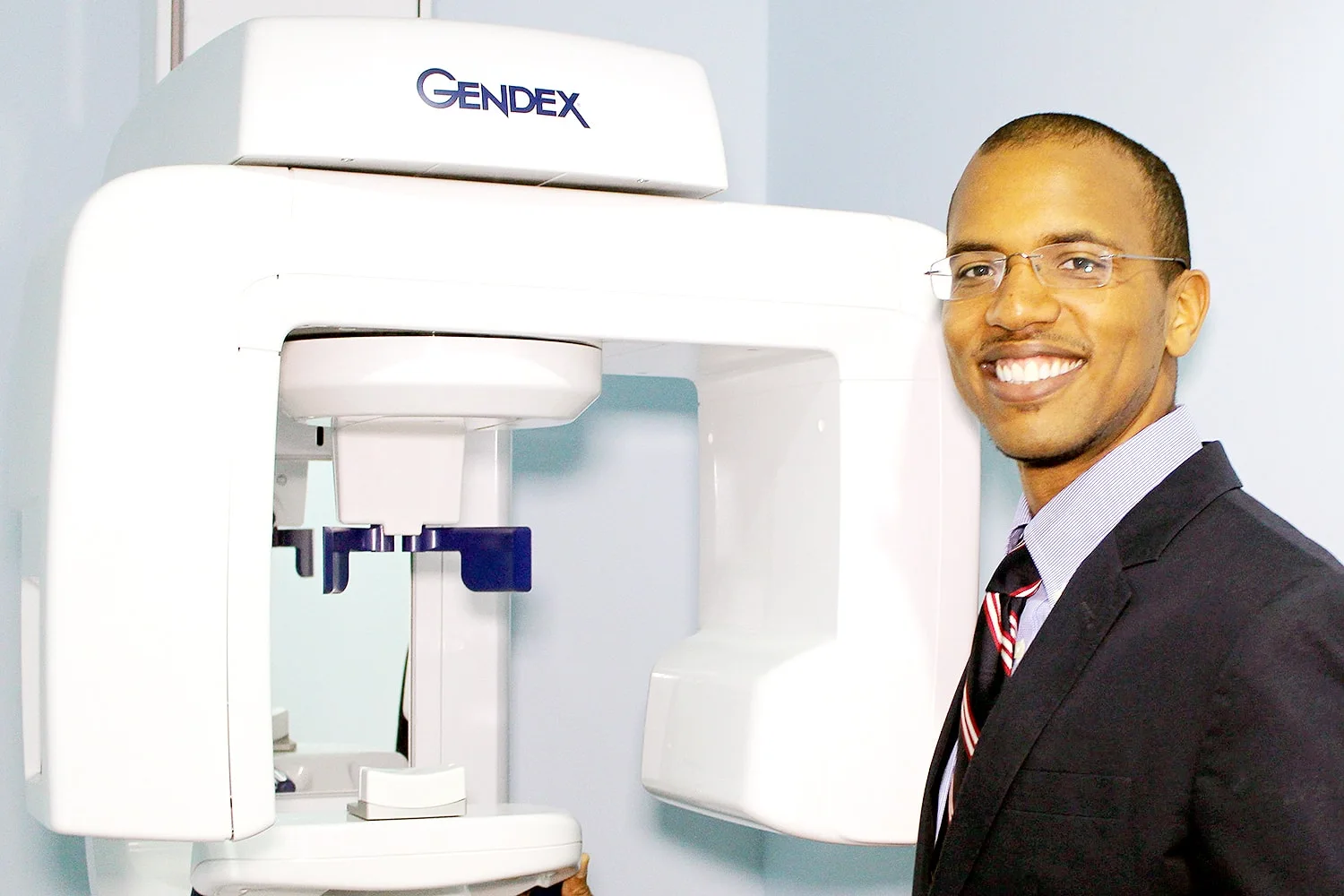 Dr. Shirley beside the digital X-ray machine